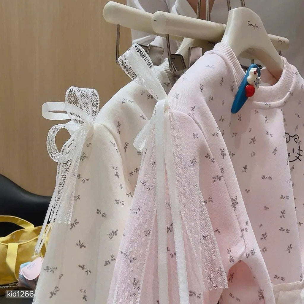 Hello Kitty sweatshirt with grey leggings.