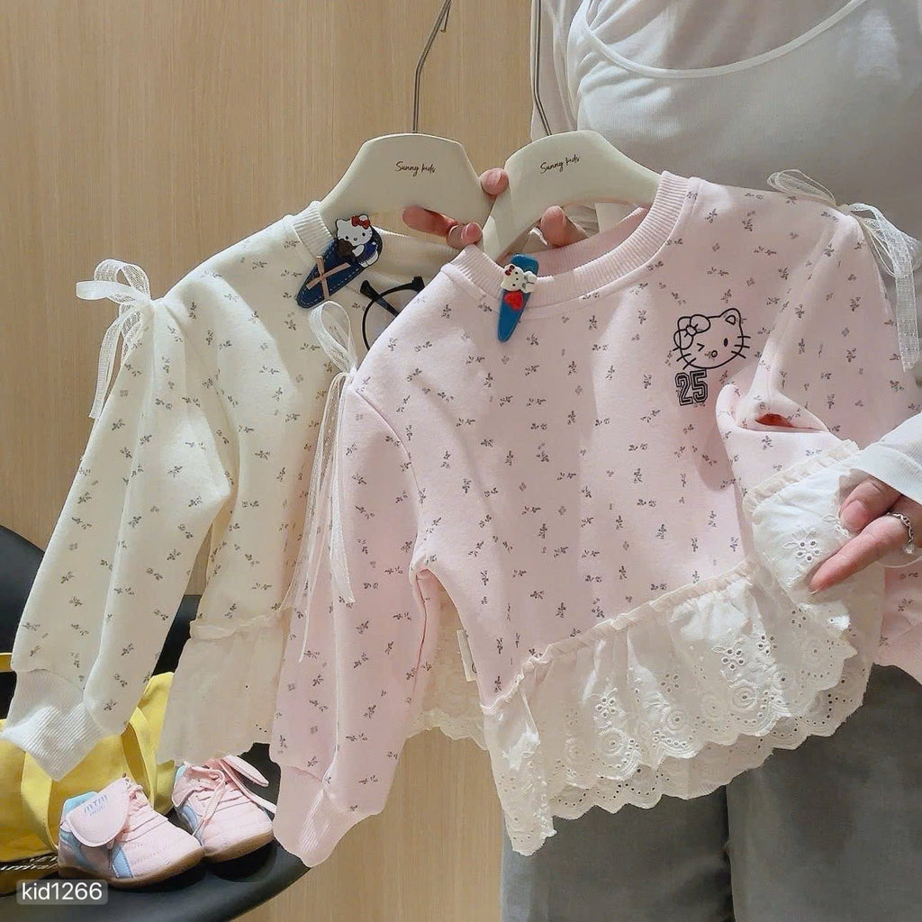 Hello Kitty sweatshirt with grey leggings.
