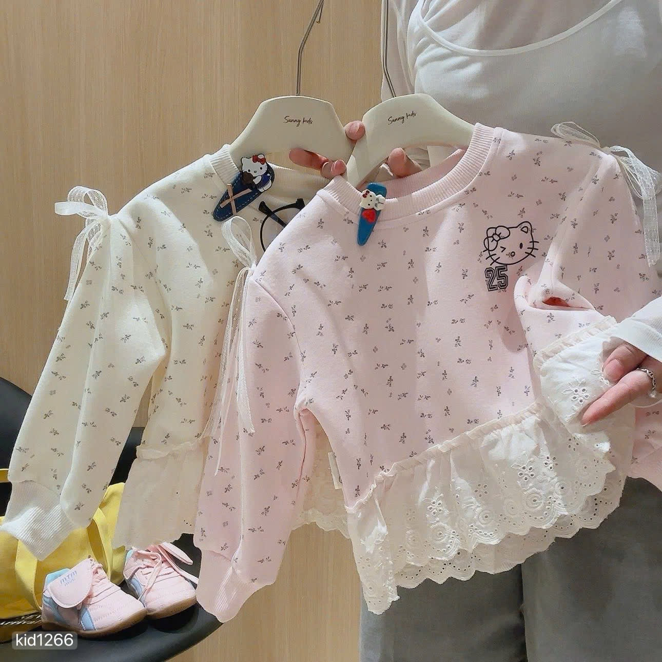 Hello Kitty sweatshirt with grey leggings.