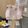 Hello Kitty sweatshirt with grey leggings.