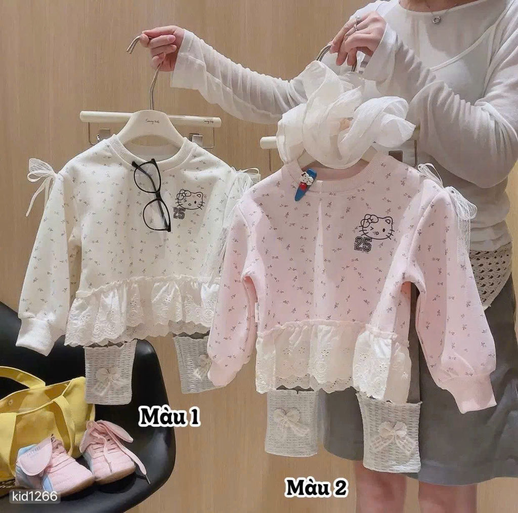 Hello Kitty sweatshirt with grey leggings.