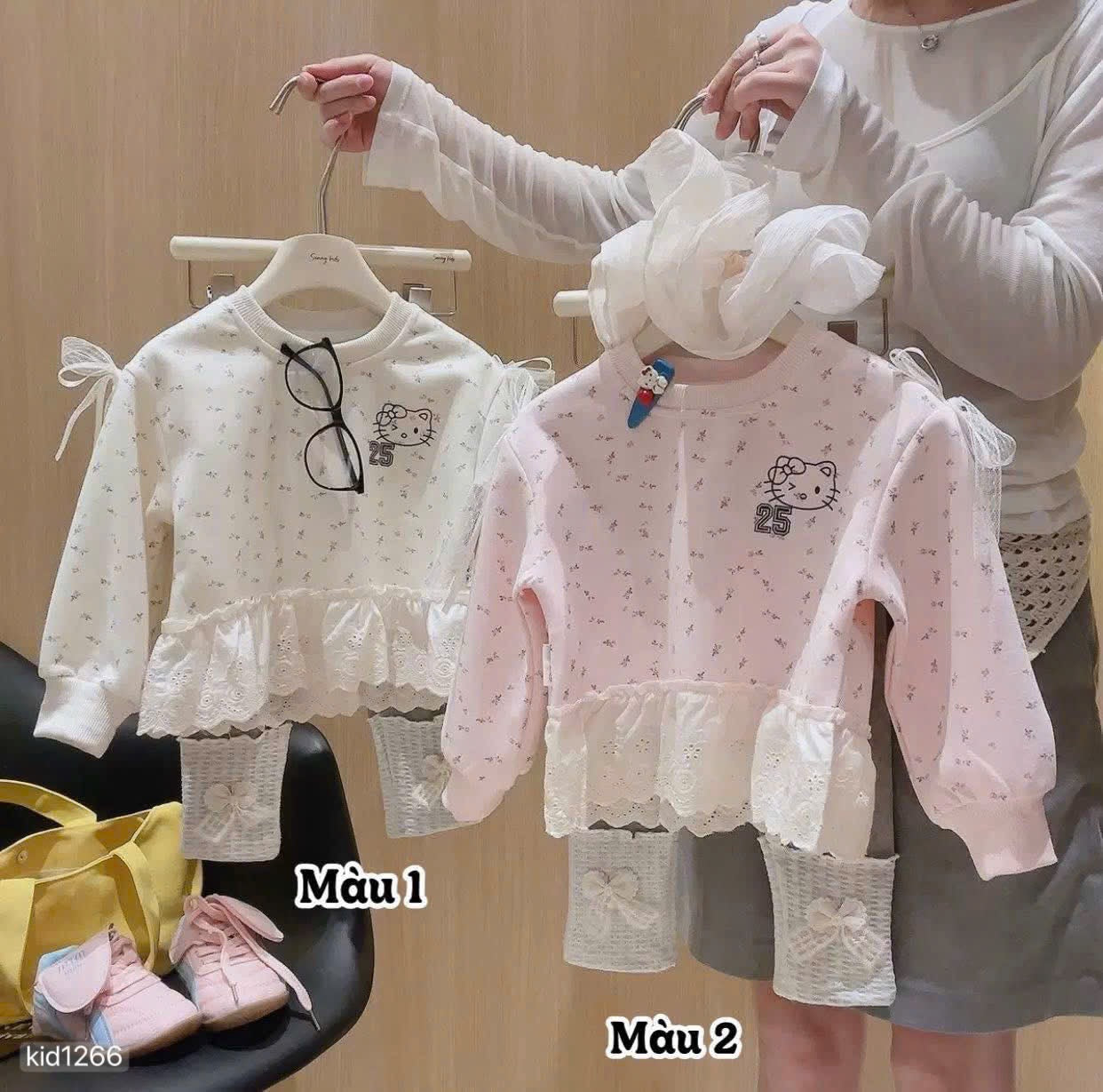 Hello Kitty sweatshirt with grey leggings.